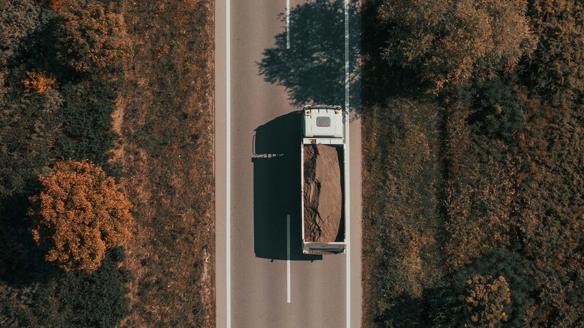 Truck_Delivering_Sand_Aerial_View_16_9-1